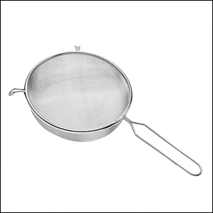 A imagem mostra uma peneira de aço inox em um fundo branco.