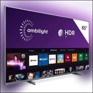 Smart-TV-Philips-Ambilight-4k-UHD-65 A imagem mostra uma tv em perspectiva, mostrando ela de lado. A tv é prata e em sua tela é possível ver um fundo roxo com as palavras Ambilight e HDR escritas em branco. Ao redor da tv, é possível ver um sombreado roxo.
