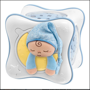 A imagem mostra uma luminária em formato de cubo nas cores branca e azul claro. Em uma das faces, há um círculo amarelo com um pequeno boneco de um bebê dormindo com uma touca azul.