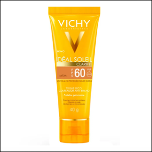 Protetor-solar-Idéal-Soleil-Clarify-Vichy A imagem mostra a embalagem do protetor solar, uma bisnaga na cor amarela, com o logo da marca em dourado e as outras informações do produto em letras brancas e pretas.