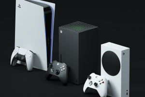 A imagem mostra os consoles dos jogos PlayStation 5, XBox Series X e XBox Series S alinhados, com seus respectivos controles na frente de cada um, num fundo preto.